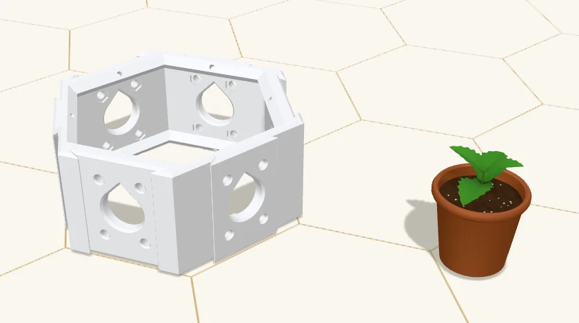 A Hex Cluster base and, beside it on the bench, a small terracotta pot of soil with a mint plant in it